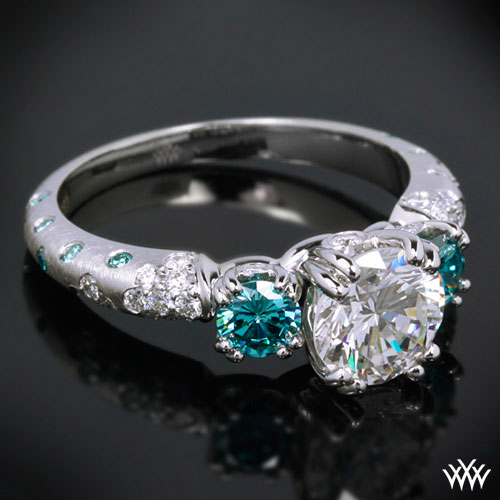 3 stone engagement ring with two blue side-stones
