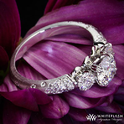 three stone diamond engagement ring and purpure flower