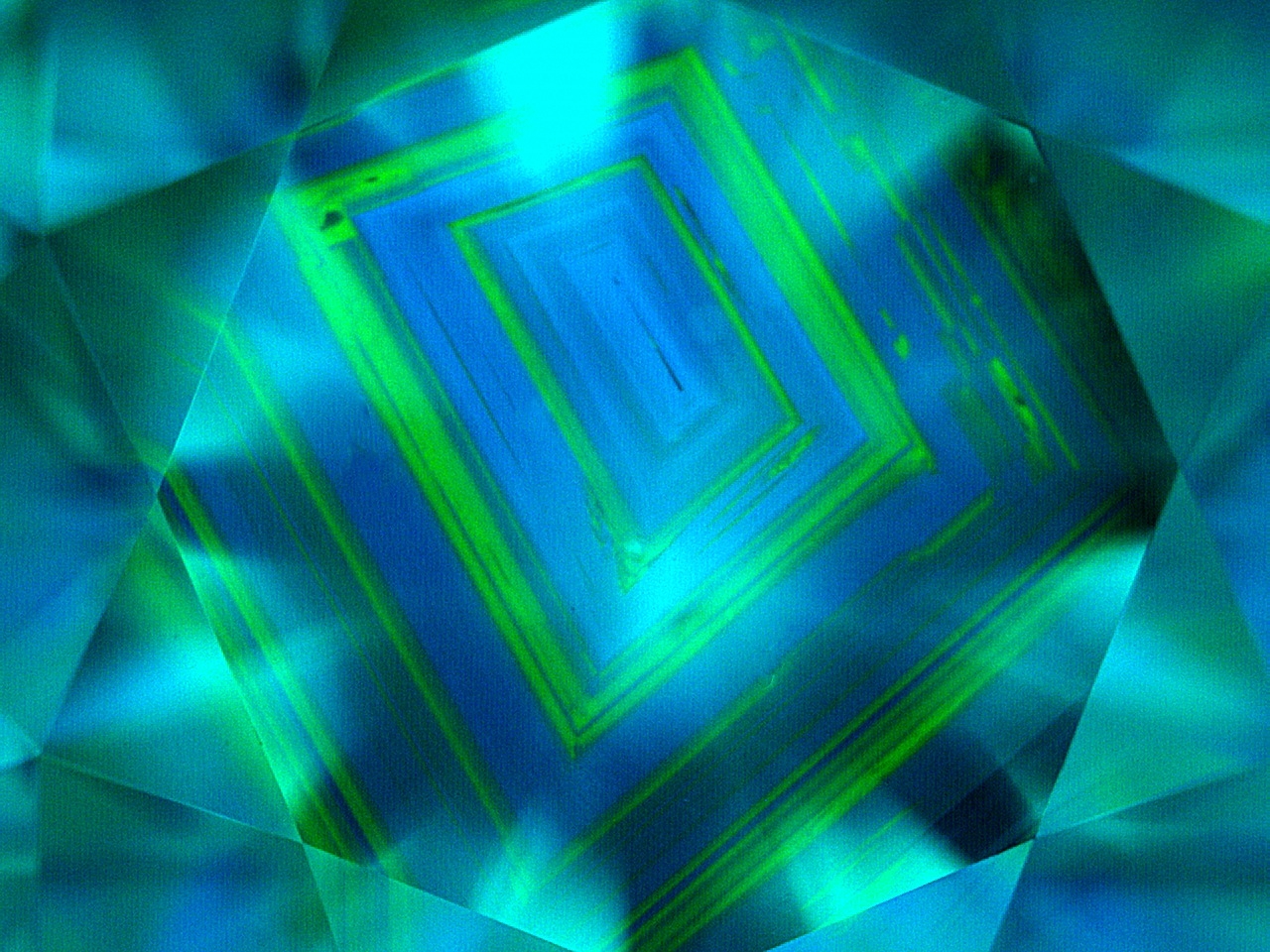 Deep UV luminescence in a natural diamond showing growth lines caused by changes in temperature and pressure during formation.  Image courtesy of GIA